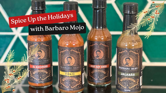 Four Barbaro Mojo hot sauce bottles, El Havanero, Piñazo, Best Day Ever and Jalabáo, against a green tile backdrop with holiday greenery