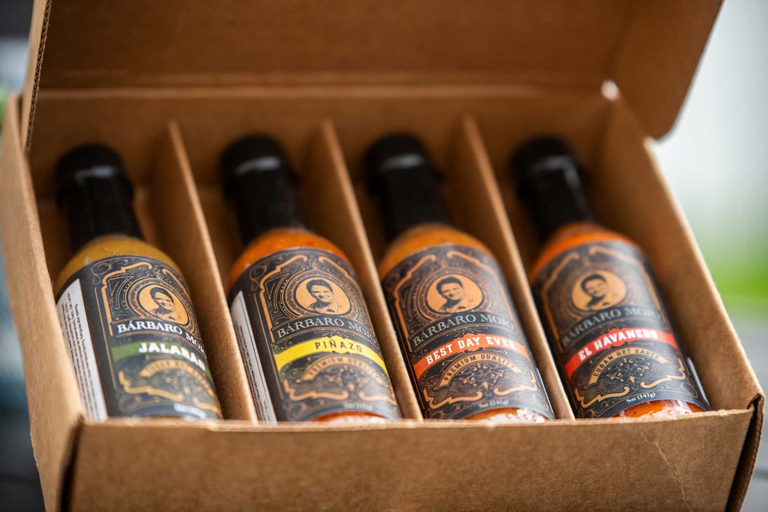 Open Barbaro Mojo gift box seen from above with four bottles, Jalabáo, Piñazo, Best Day Ever and El Havanero