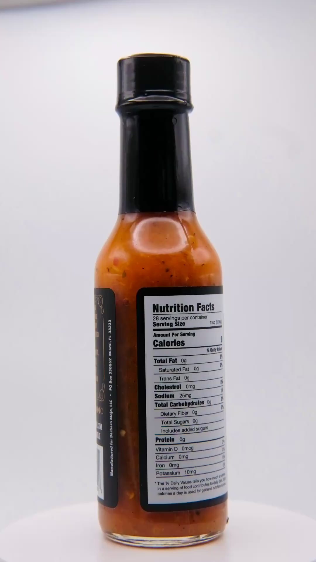 360 degree spin of a bottle of Barbaro Mojo Piñazo Cuban hot sauce with the new foil label