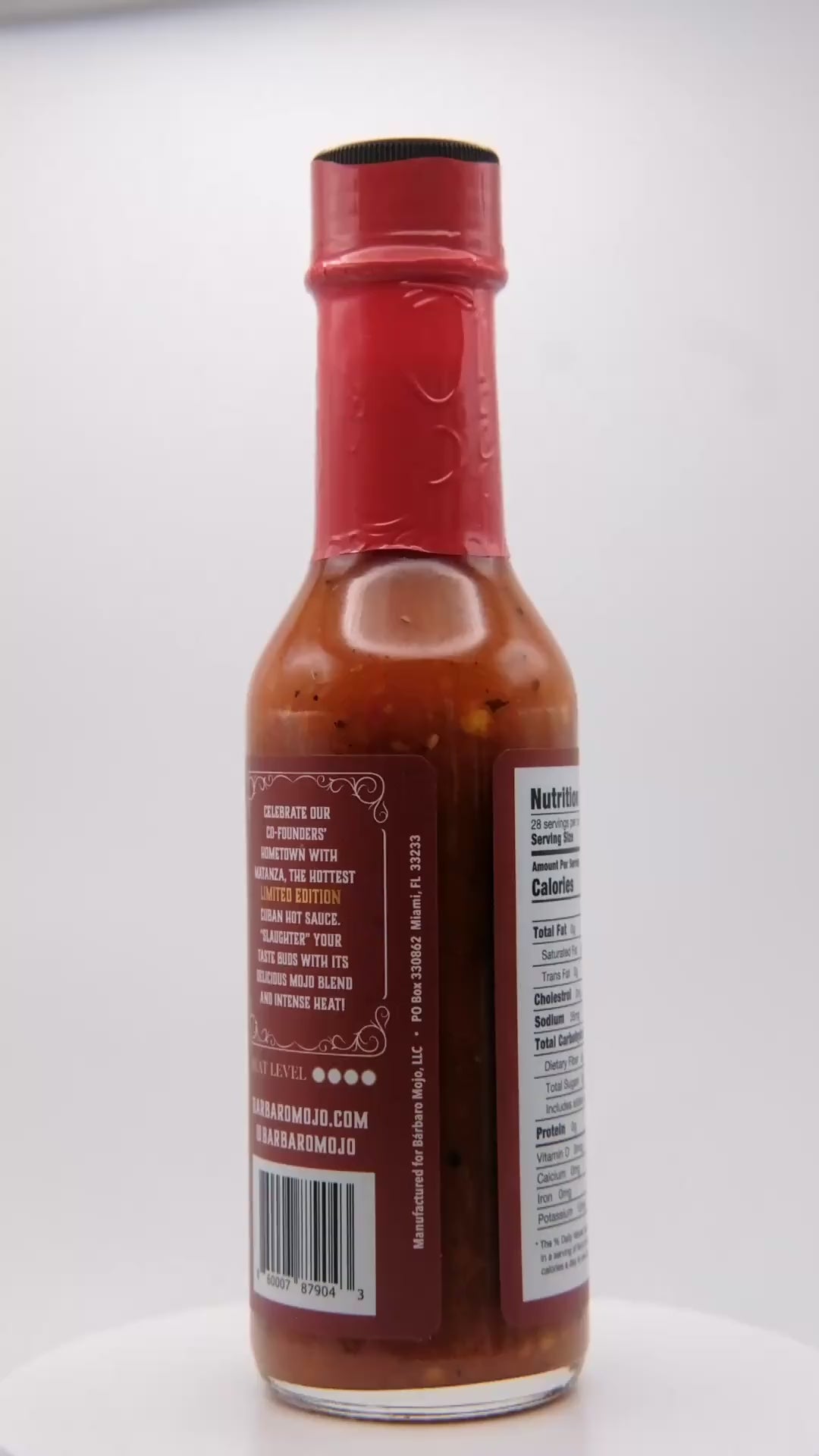 360 degree spin of a bottle of Barbaro Mojo Matanza Cuban hot sauce with the new foil label